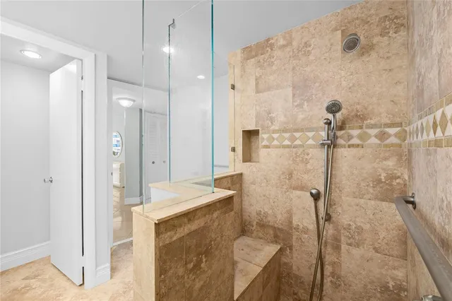 a bathroom with a granite countertop sink a toilet and a mirror