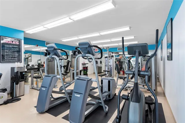 a living room with furniture and a book shelf