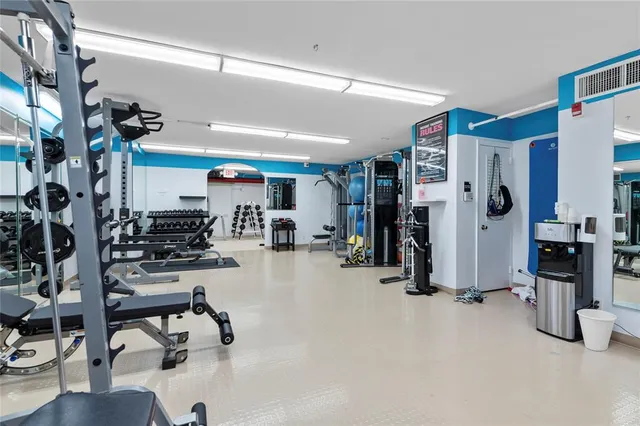 a room with pool table and windows