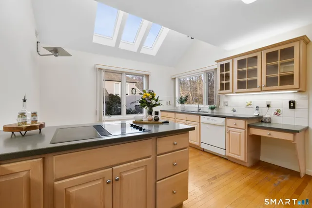a kitchen with sink stove and cabinets