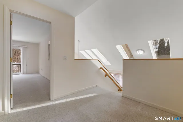 a spacious bedroom with a bed and a large window