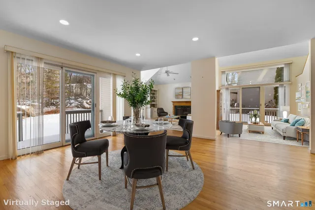 a living room with fireplace furniture and a large window