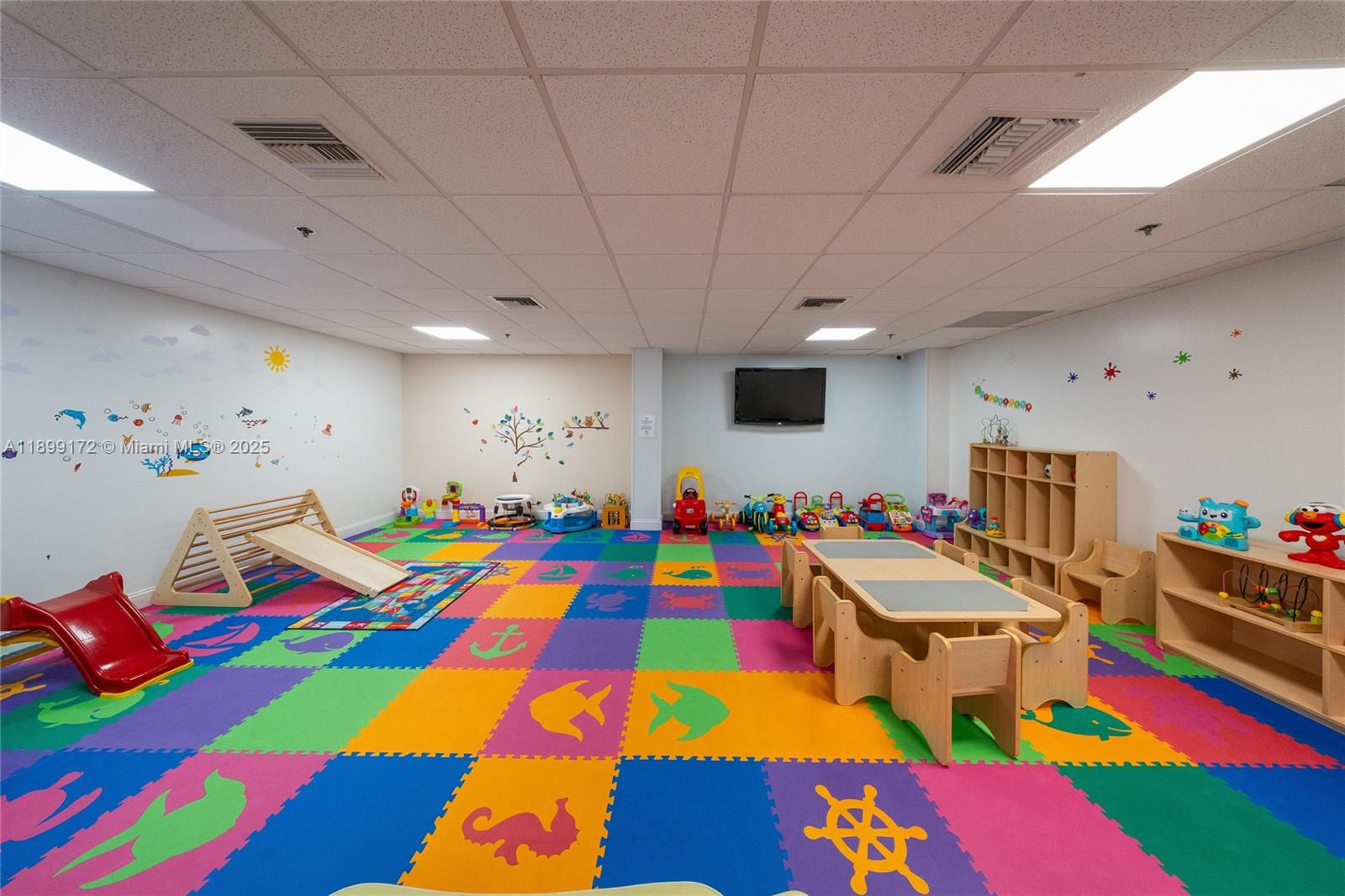 540 Brickell Key Drive, Unit 202 Miami, FL 33131 - Photo 13 of 60 a room with lots of baby toys and wooden floor