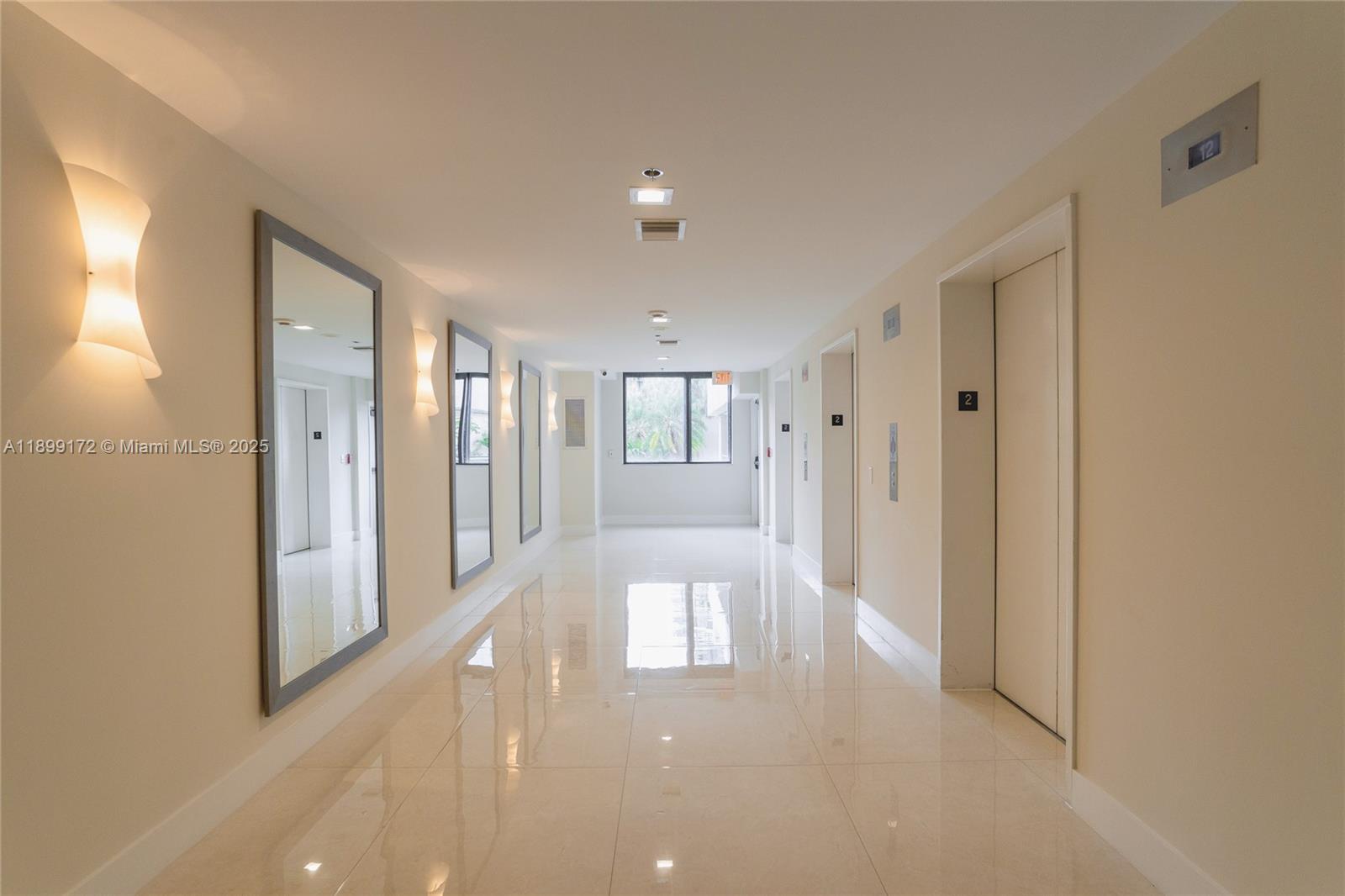 540 Brickell Key Drive, Unit 202 Miami, FL 33131 - Photo 17 of 60 a view of a hallway with wooden floor and cabinet