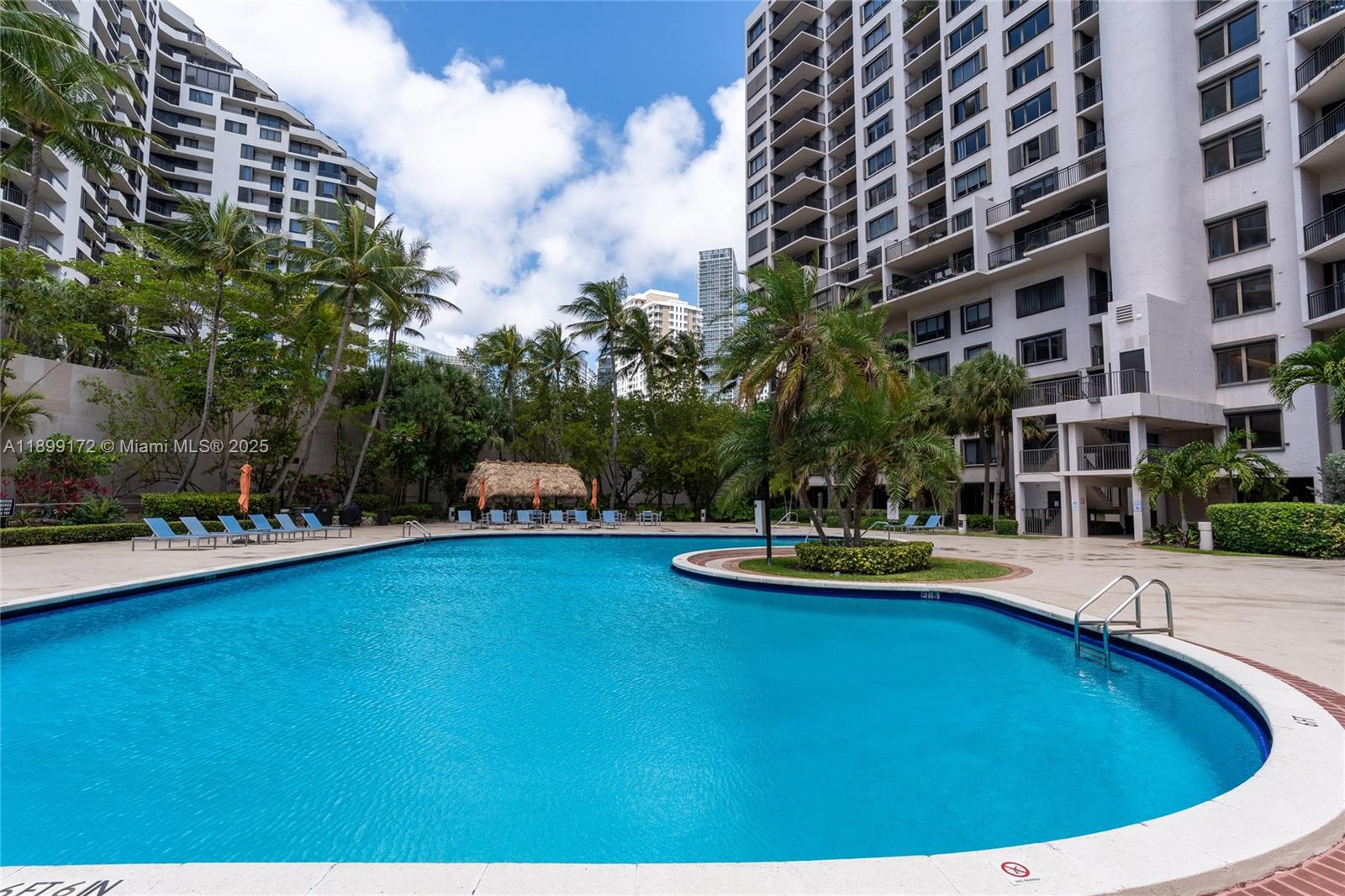 540 Brickell Key Drive, Unit 202 Miami, FL 33131 - Photo 18 of 60 a swimming pool with outdoor seating and yard
