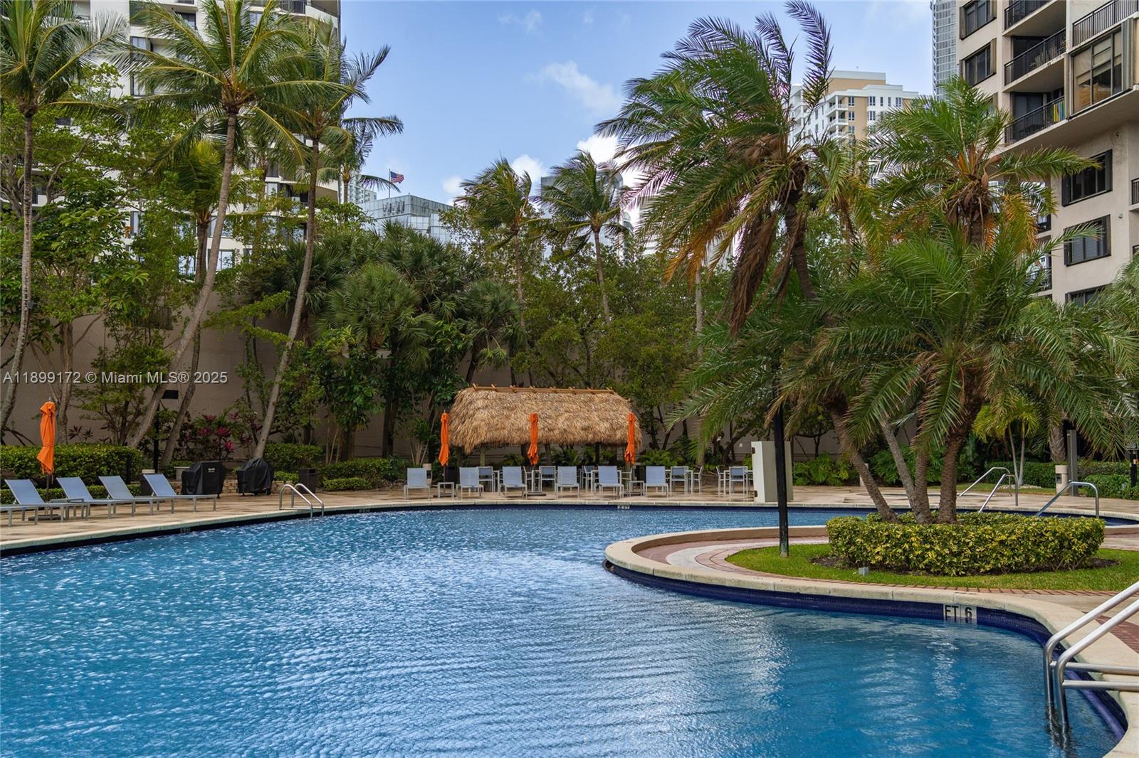 540 Brickell Key Drive, Unit 202 Miami, FL 33131 - Photo 19 of 60 a swimming pool with outdoor seating and yard