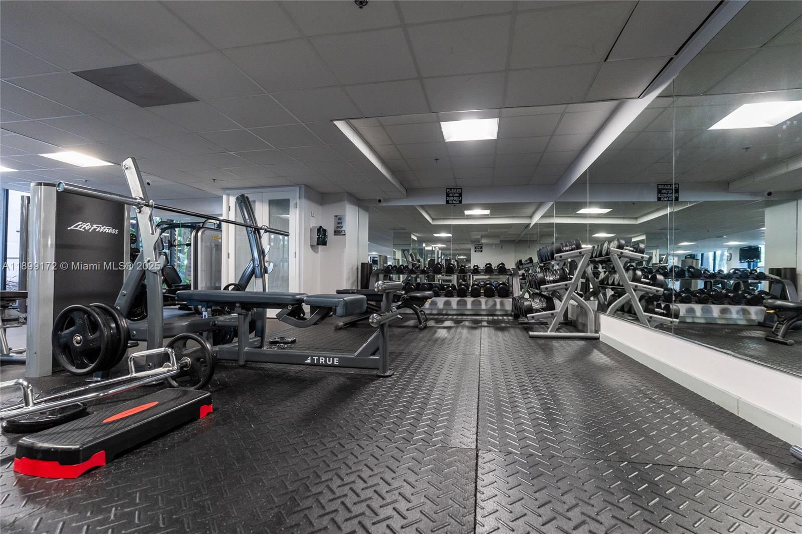 540 Brickell Key Drive, Unit 202 Miami, FL 33131 - Photo 26 of 60 a living room with lots of gym equipment