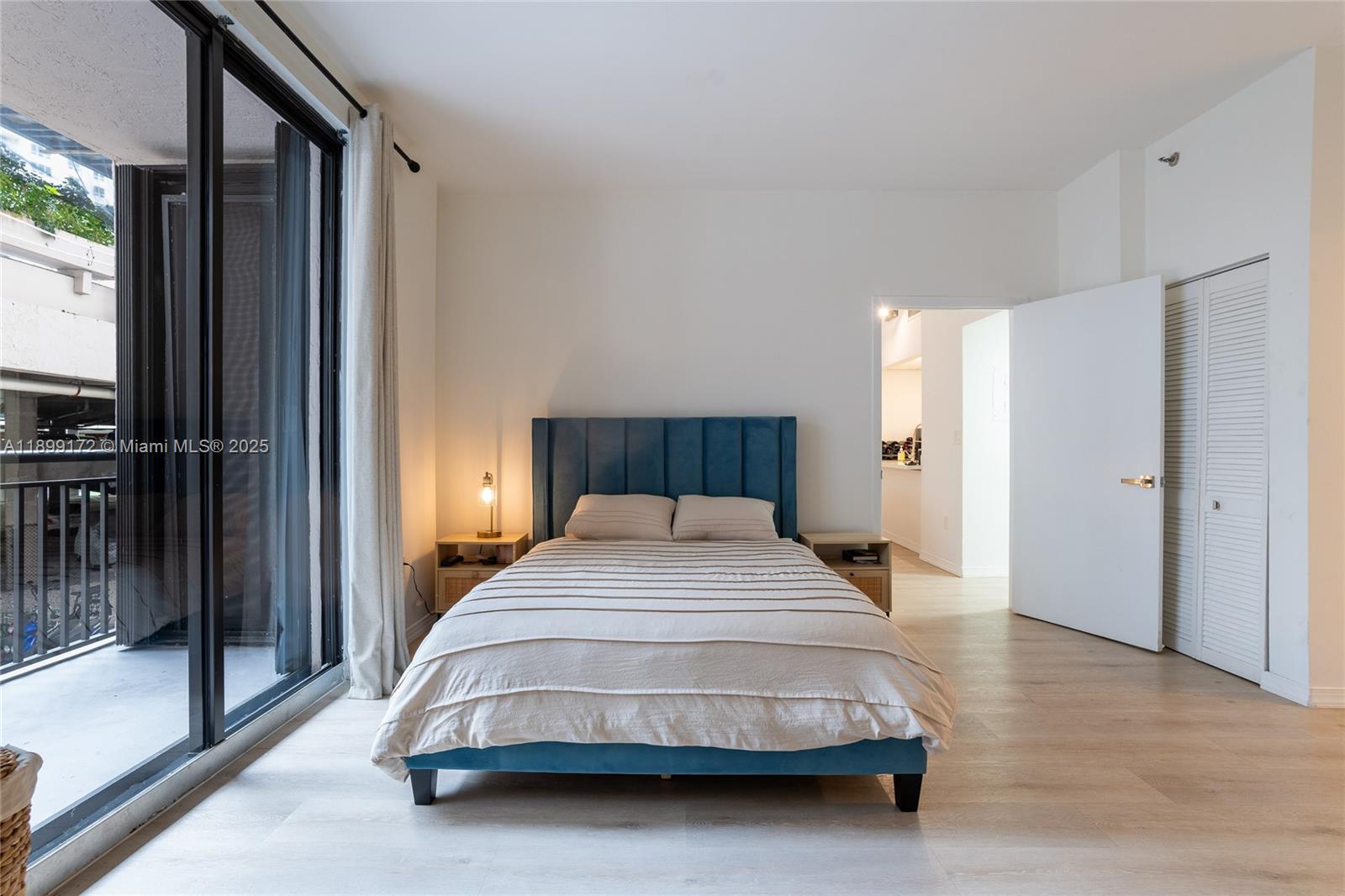 540 Brickell Key Drive, Unit 202 Miami, FL 33131 - Photo 37 of 60 a bedroom with a bed and a large window