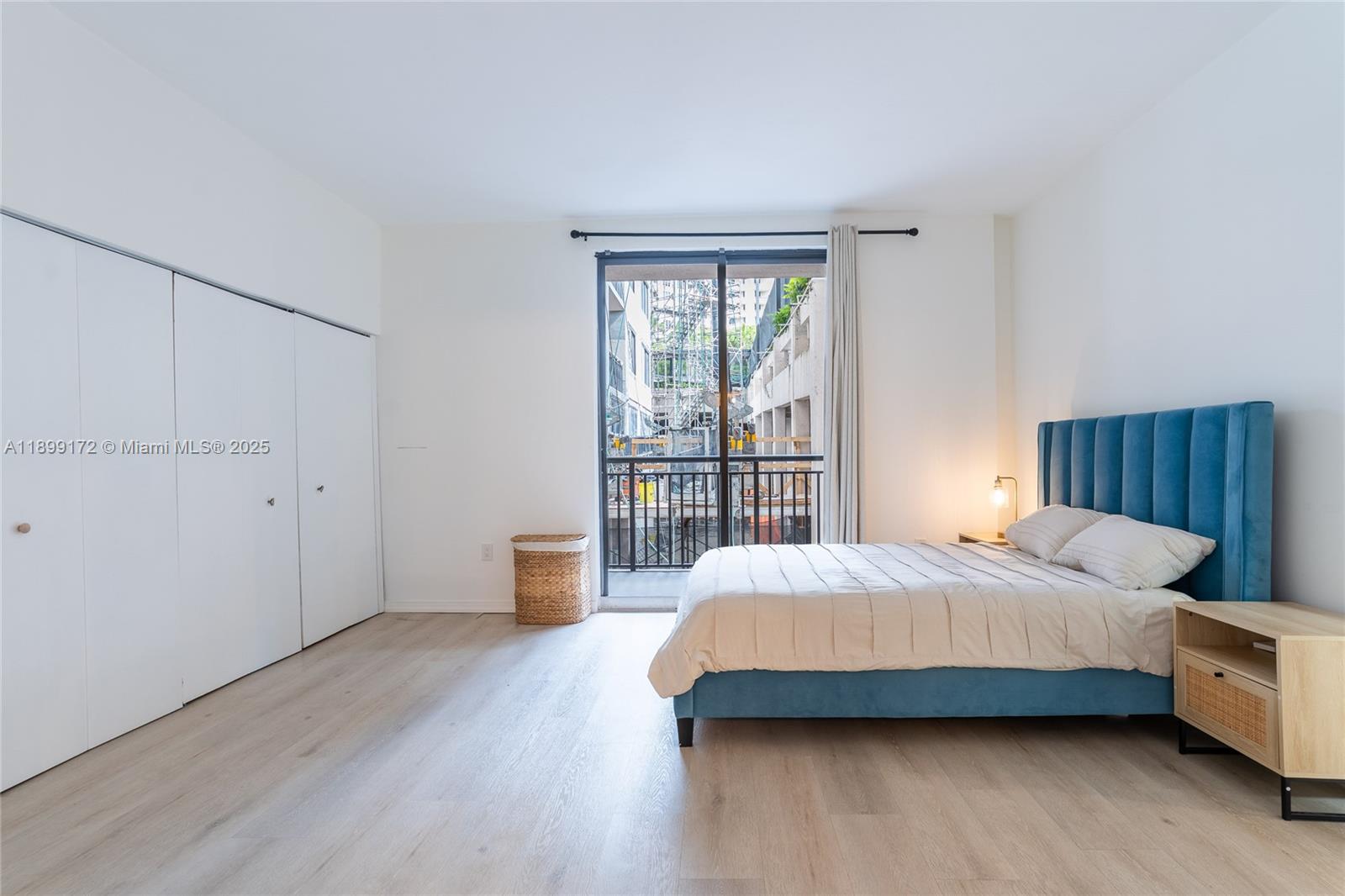 540 Brickell Key Drive, Unit 202 Miami, FL 33131 - Photo 39 of 60 a bedroom with a bed and wooden floor