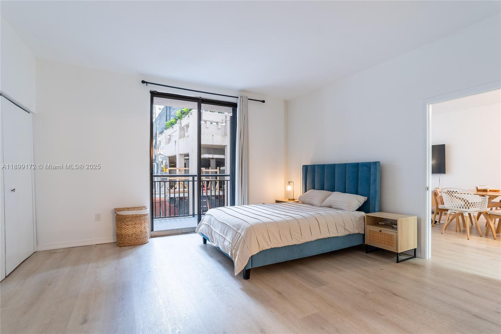 540 Brickell Key Drive, Unit 202 Miami, FL 33131 - Photo 40 of 60 a bedroom with a bed and a table with wooden floor