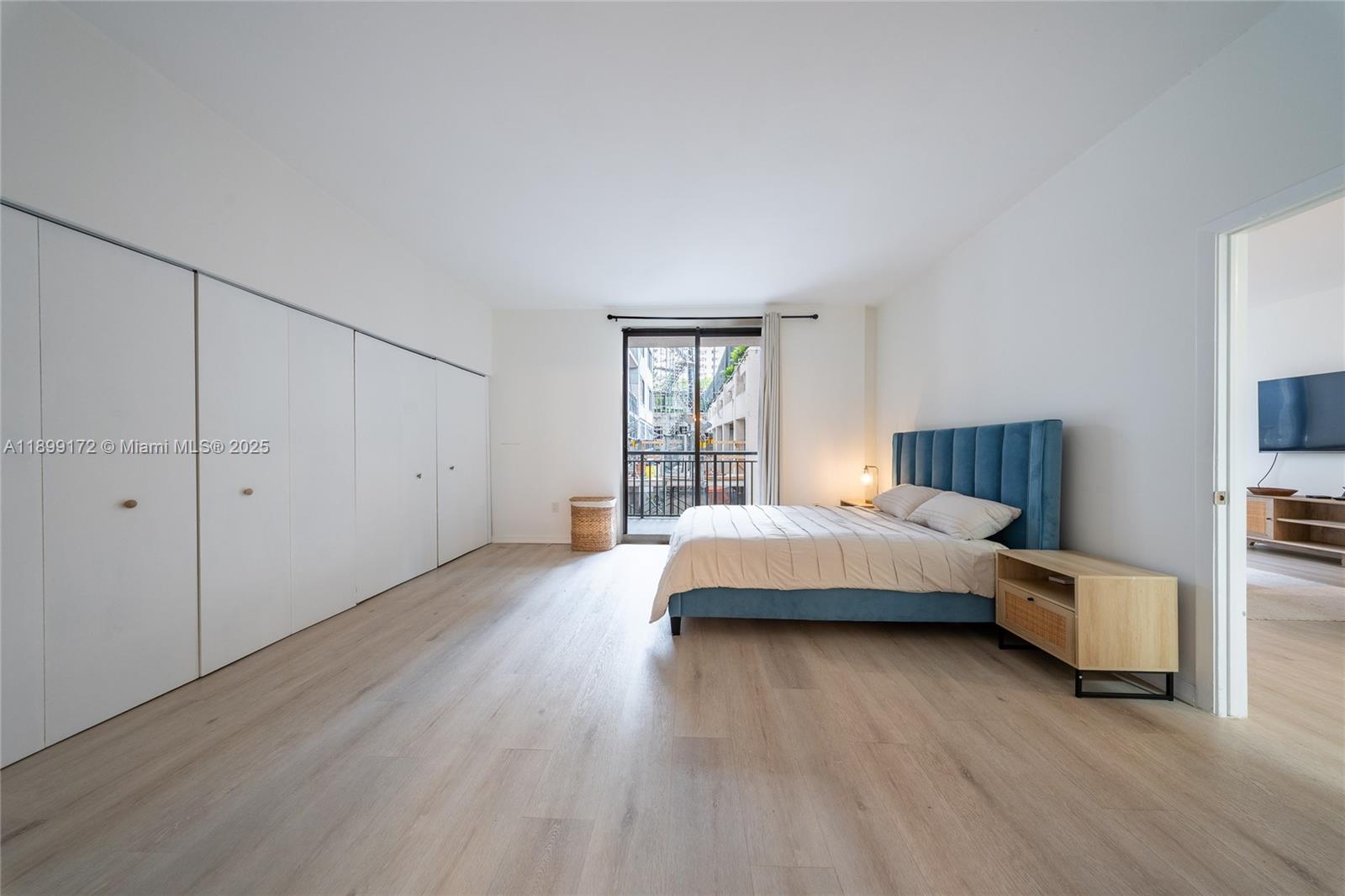 540 Brickell Key Drive, Unit 202 Miami, FL 33131 - Photo 41 of 60 a spacious bedroom with a bed and wooden floor