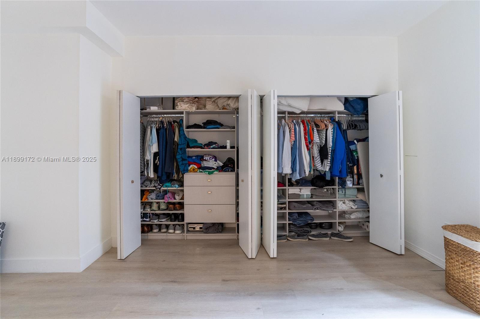540 Brickell Key Drive, Unit 202 Miami, FL 33131 - Photo 44 of 60 a view of walk in closet with clothes and shoes