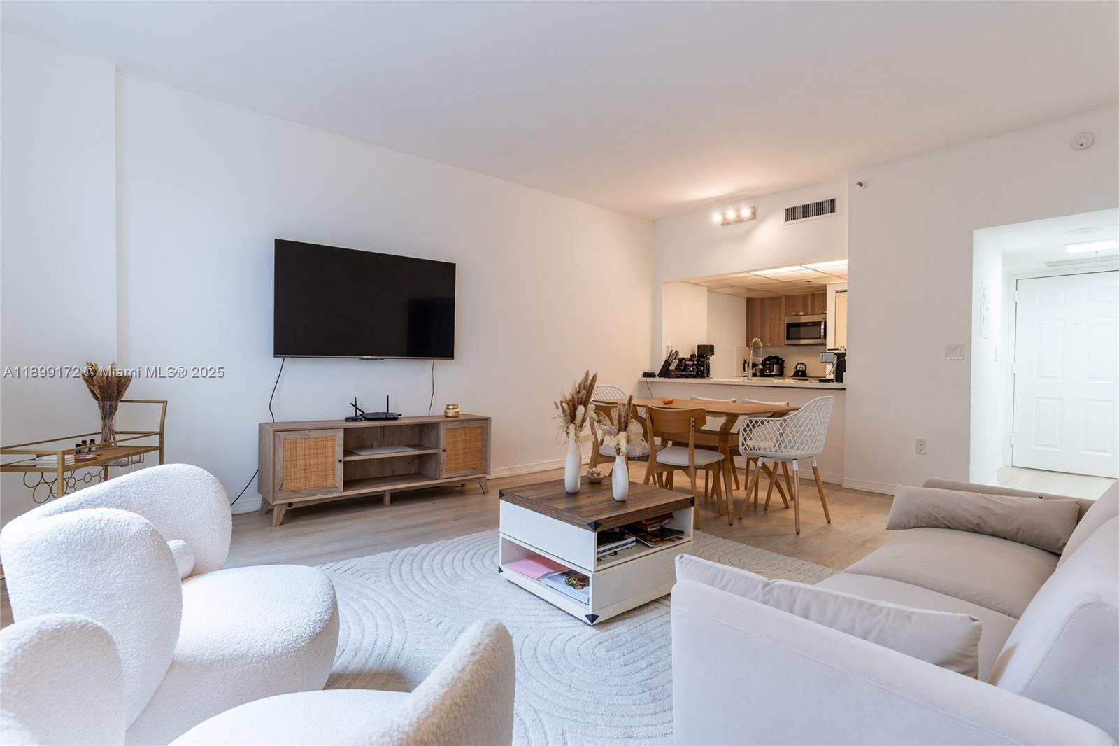 540 Brickell Key Drive, Unit 202 Miami, FL 33131 - Photo 46 of 60 a living room with furniture and a flat screen tv