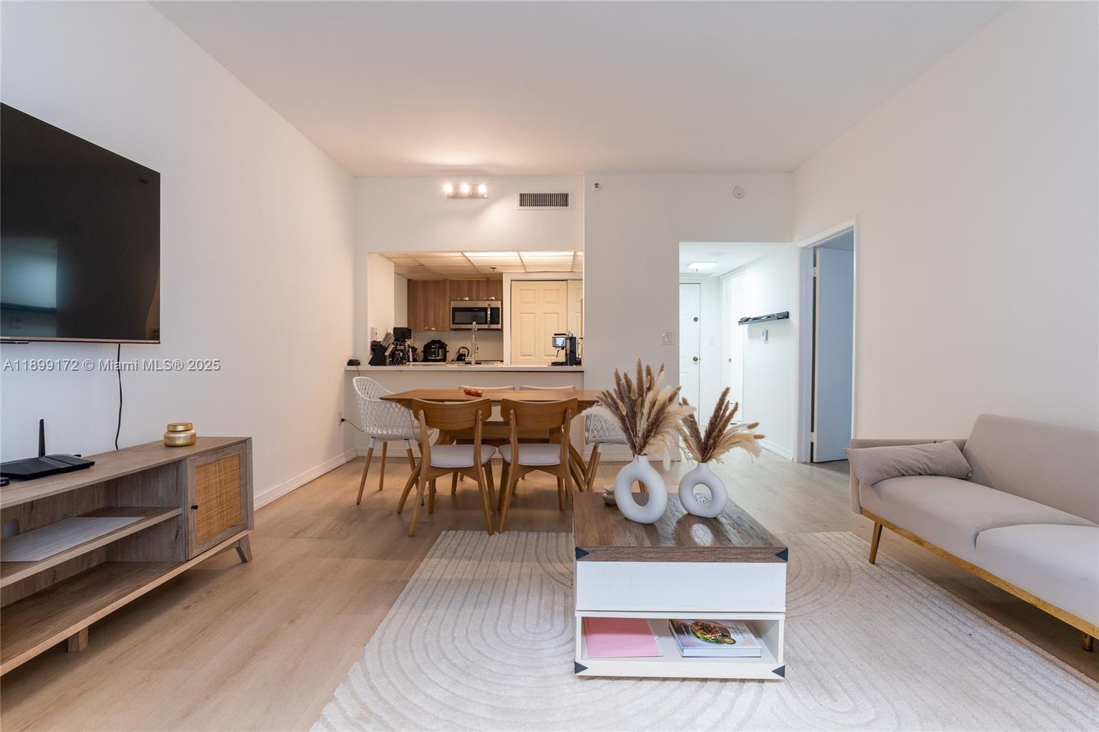 540 Brickell Key Drive, Unit 202 Miami, FL 33131 - Photo 47 of 60 a living room with furniture and a flat screen tv