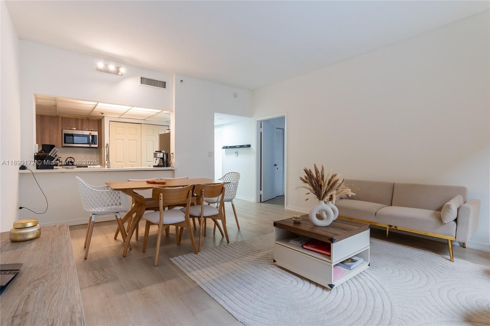 540 Brickell Key Drive, Unit 202 Miami, FL 33131 - Photo 48 of 60 a living room with furniture kitchen view and a dining table