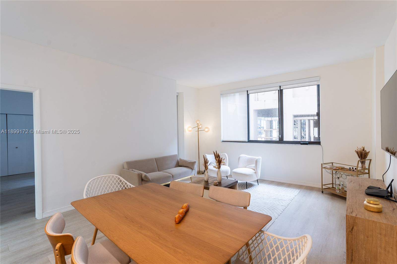 540 Brickell Key Drive, Unit 202 Miami, FL 33131 - Photo 49 of 60 a bedroom with a bed and wooden floor