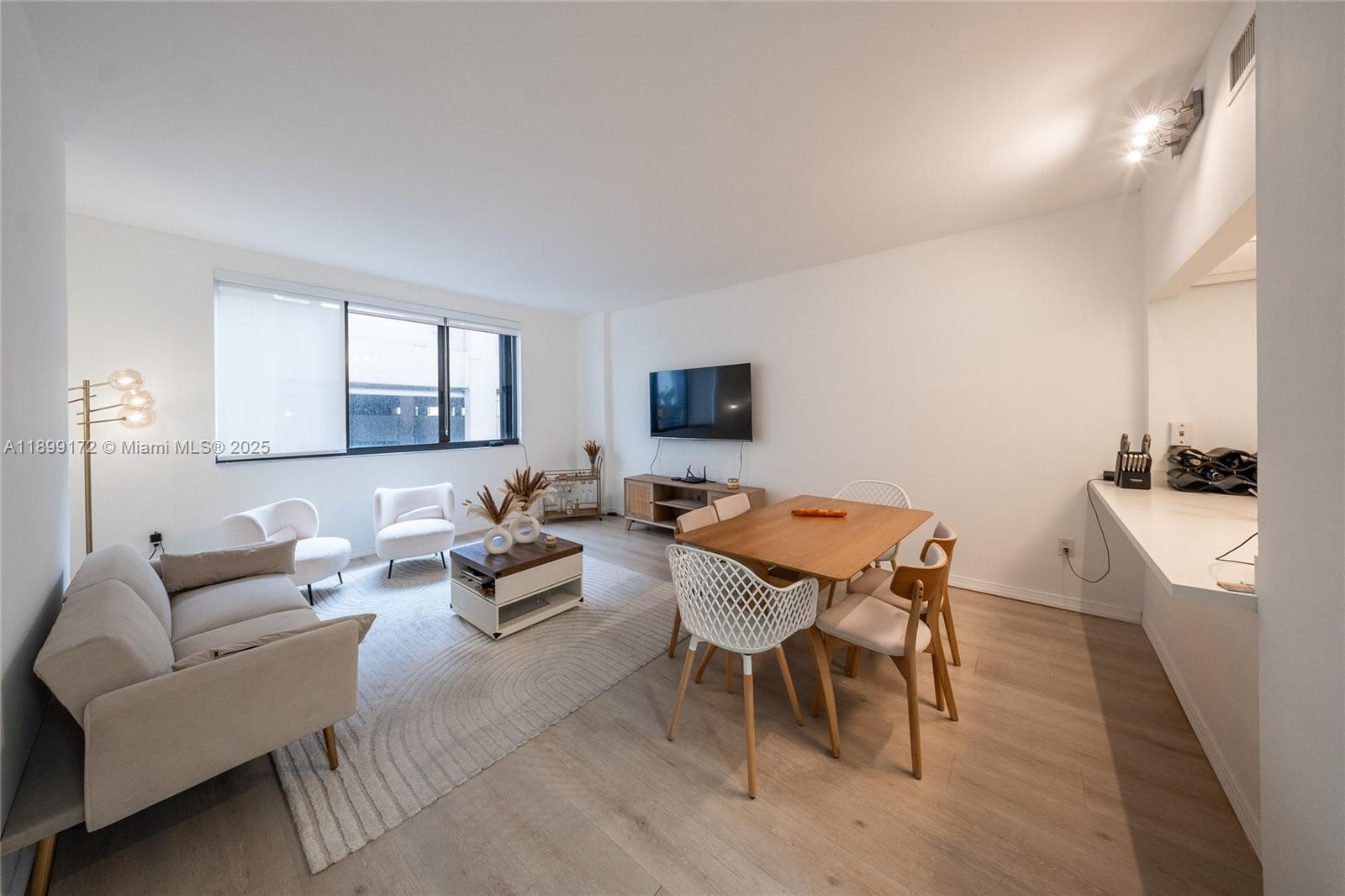 540 Brickell Key Drive, Unit 202 Miami, FL 33131 - Photo 51 of 60 a living room with furniture and a flat screen tv