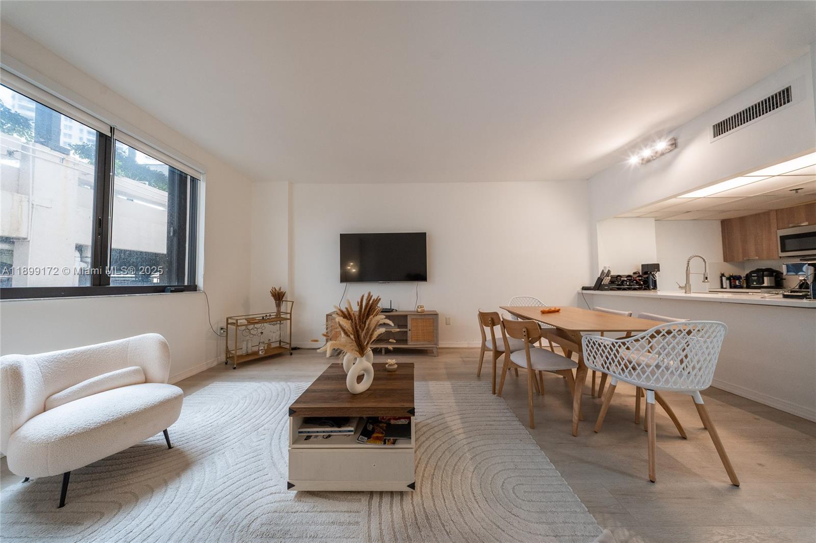 540 Brickell Key Drive, Unit 202 Miami, FL 33131 - Photo 52 of 60 a living room with furniture and a flat screen tv