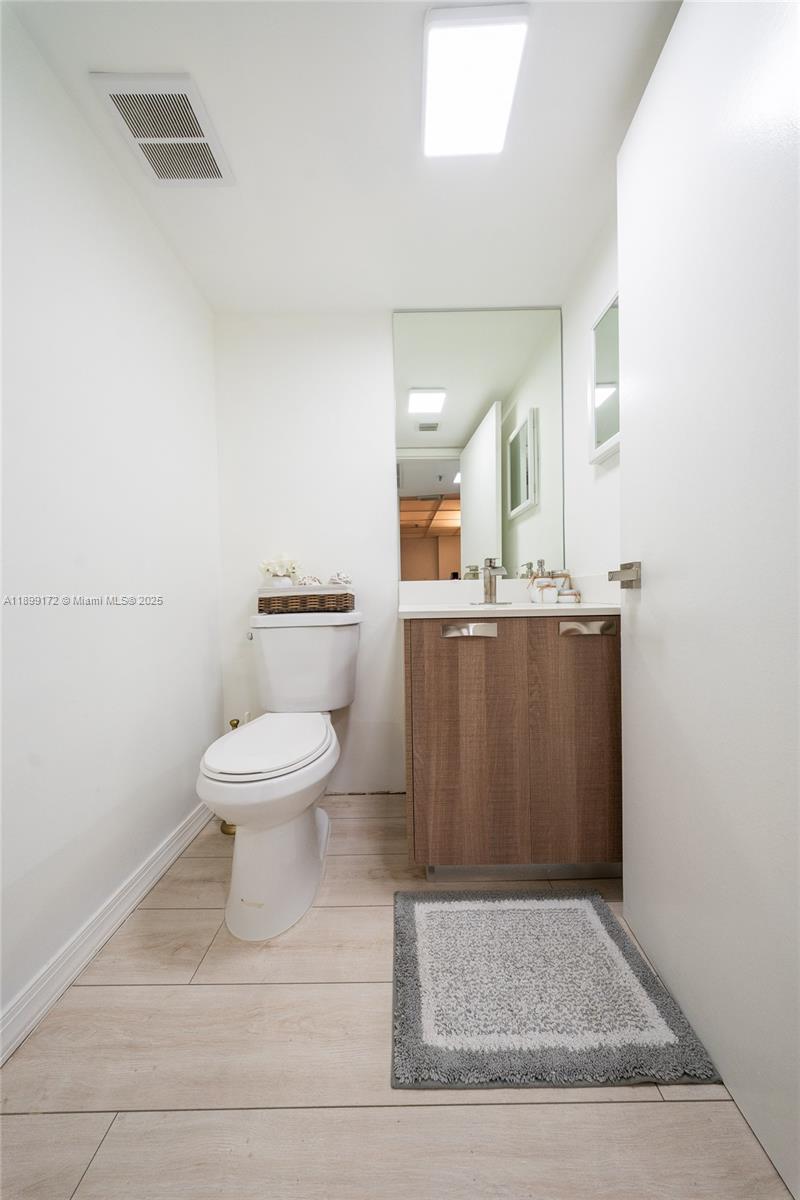 540 Brickell Key Drive, Unit 202 Miami, FL 33131 - Photo 57 of 60 a white toilet sitting next to a bathroom sink