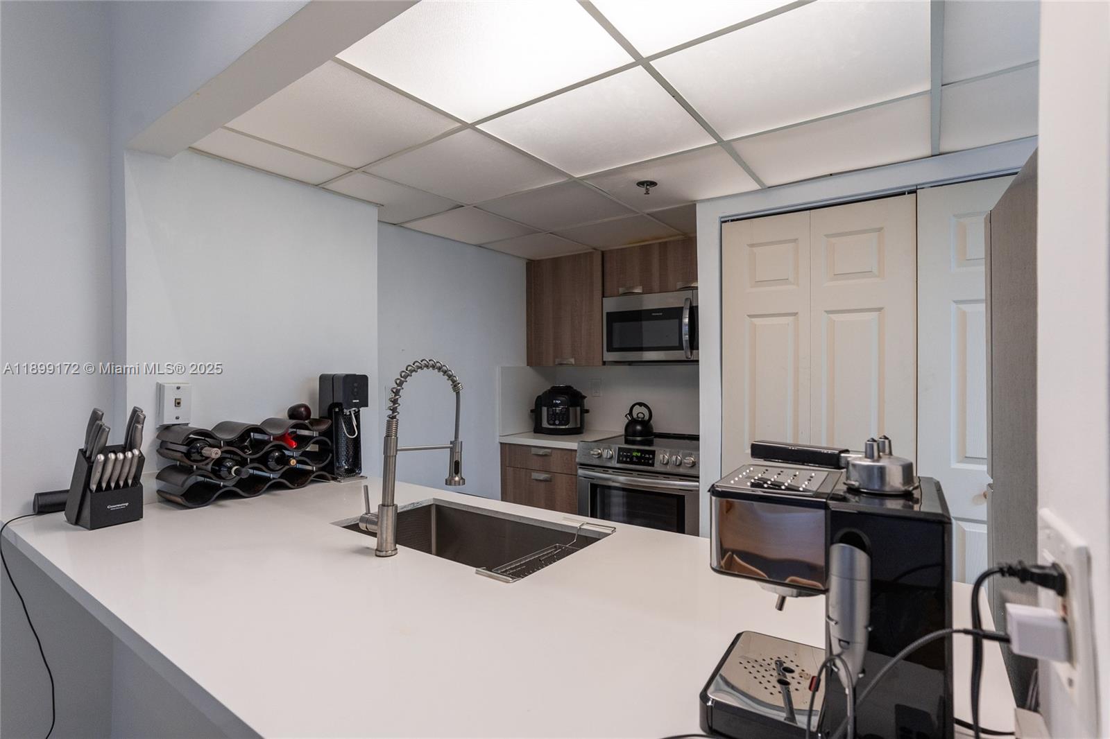 540 Brickell Key Drive, Unit 202 Miami, FL 33131 - Photo 58 of 60 a kitchen with a sink a stove and cabinets