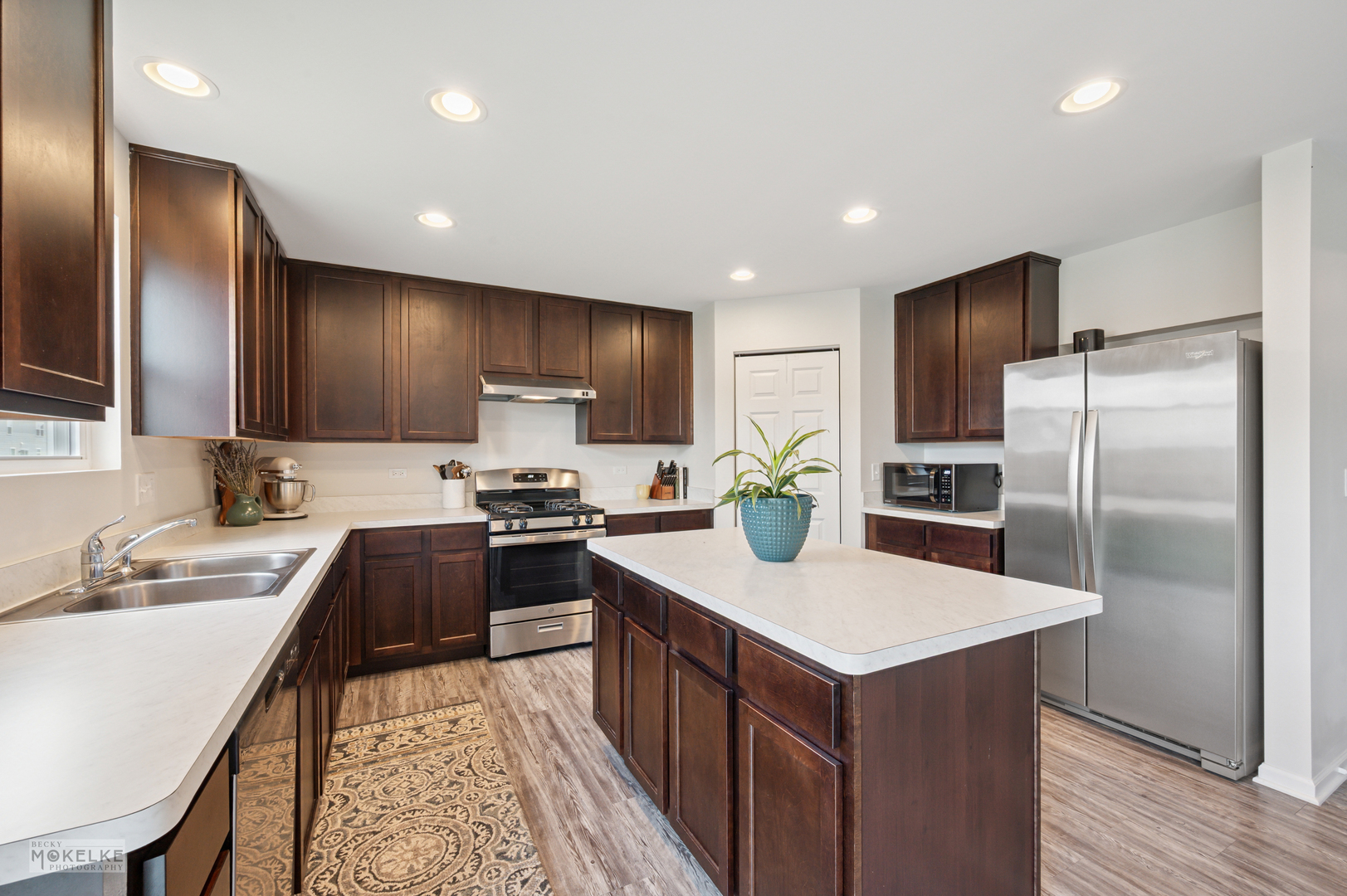 1024 Daniel Street Plano, IL 60545 - Photo 13 of 27 a kitchen with kitchen island granite countertop stainless steel appliances cabinets a sink and a counter top space