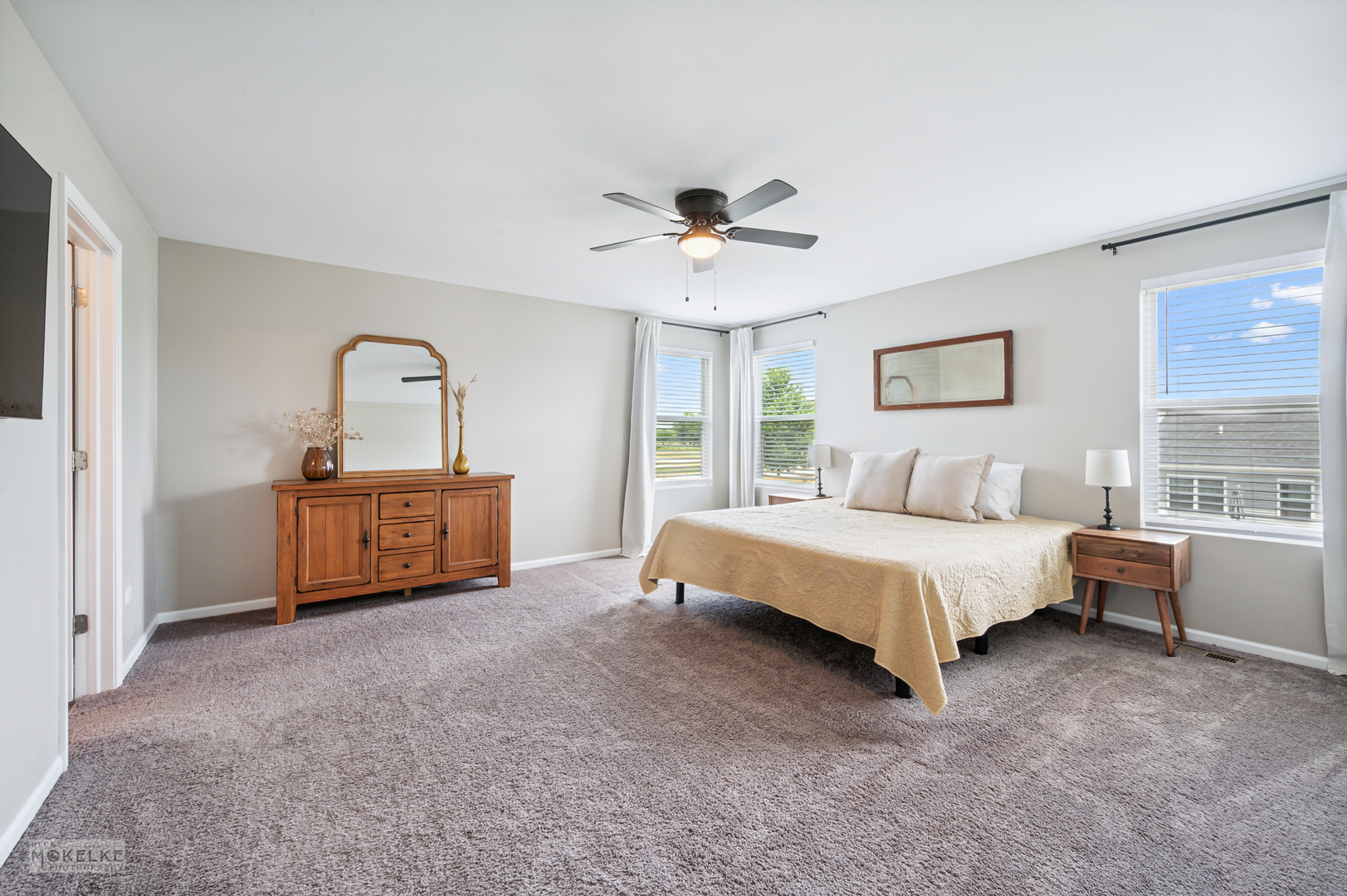 1024 Daniel Street Plano, IL 60545 - Photo 23 of 27 a spacious bedroom with a bed and a ceiling fan