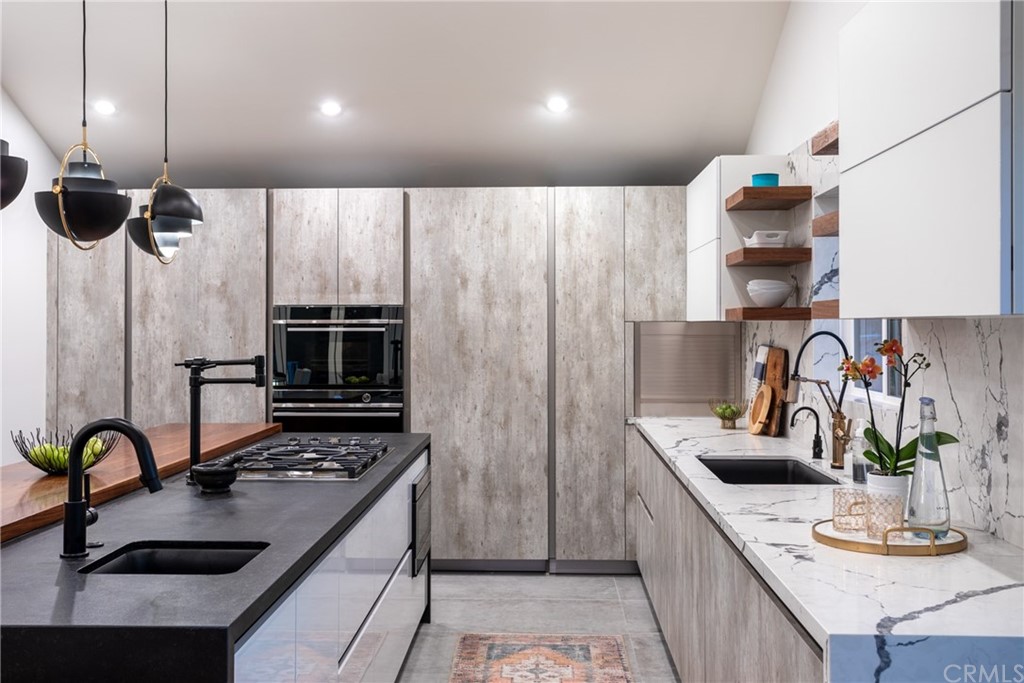 447 Avenida Crespi San Clemente, CA 92672 - Photo 19 of 42 a kitchen with kitchen island granite countertop a sink stainless steel appliances and cabinets