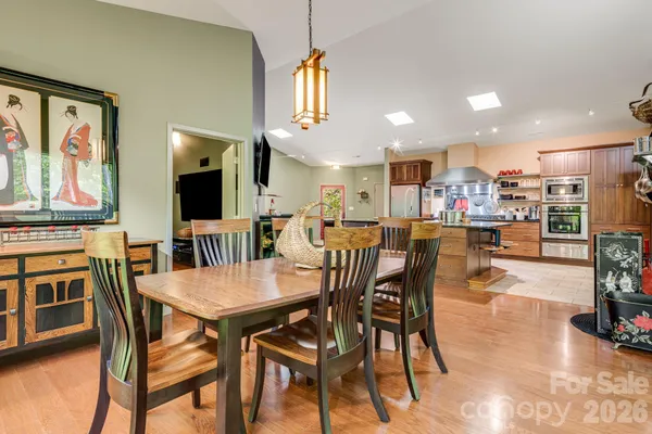 a dining area with furniture and a flat screen tv