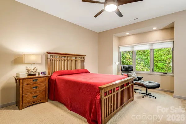 a bedroom with a bed dresser and a window