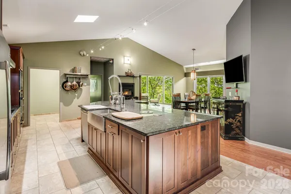 a kitchen with kitchen island granite countertop a sink counter top space and stainless steel appliances