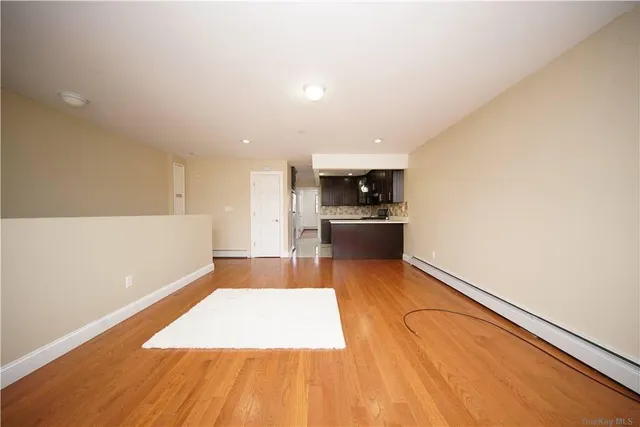 a view of kitchen with sink and refrigerator