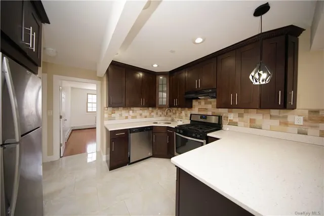 a kitchen with granite countertop a sink and stainless steel appliances