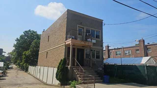 a view of a house with wooden fence