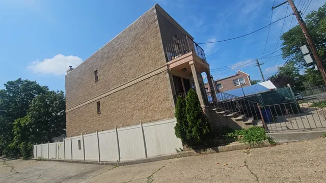a view of a house with wooden fence