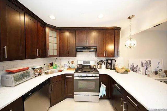 a kitchen with a sink cabinets and window