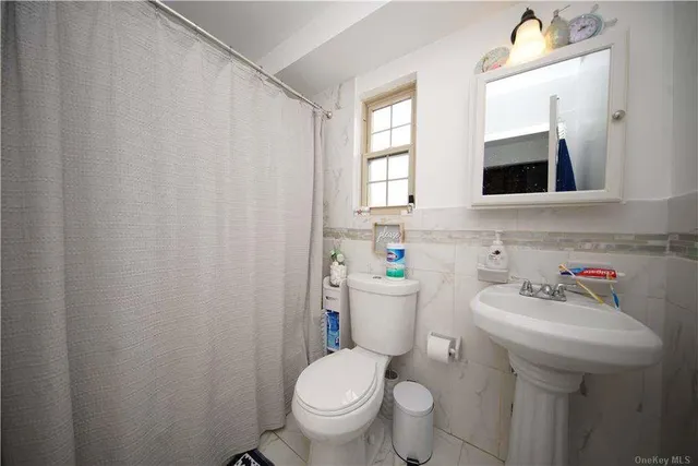 a bathroom with a sink toilet and mirror