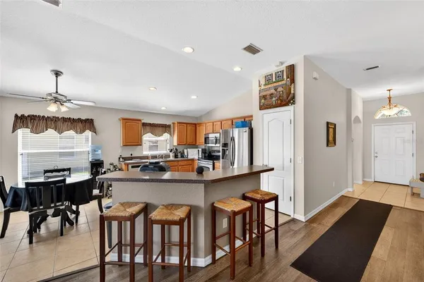 a kitchen with a dining table chairs and white cabinets