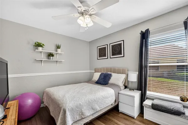 a bedroom with furniture and a flat screen tv