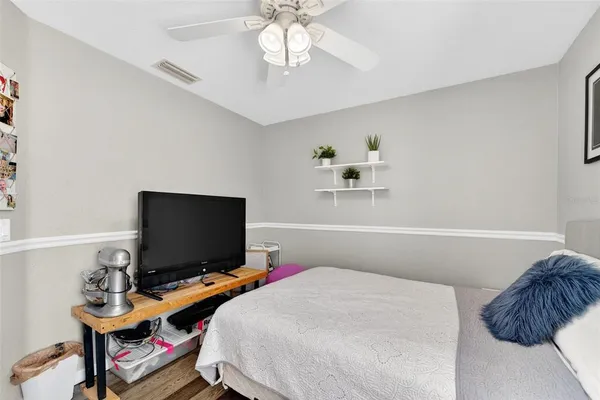 a bedroom with a bed furniture and a flat screen tv