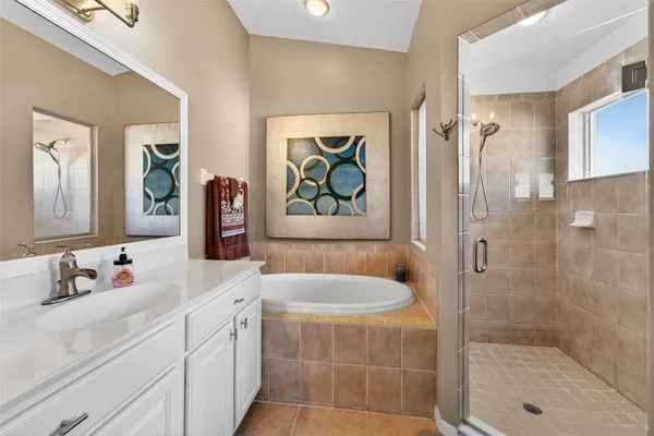 a bathroom with a bathtub a sink and a mirror