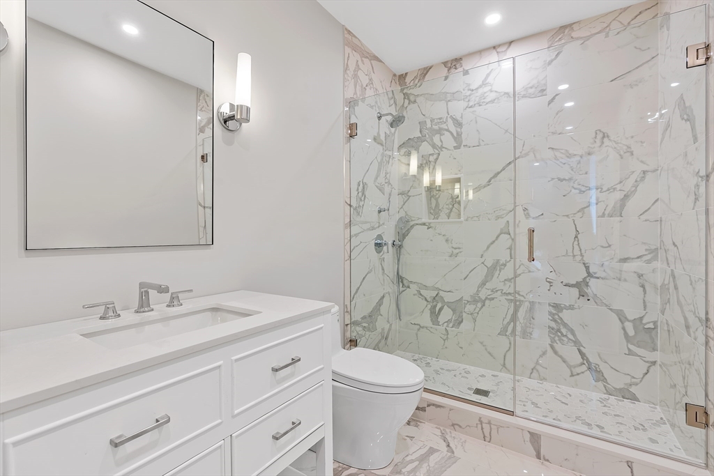 5 Colonial Road, Unit 5 Needham, MA 02492 - Photo 11 of 35 a bathroom with a sink a toilet and shower