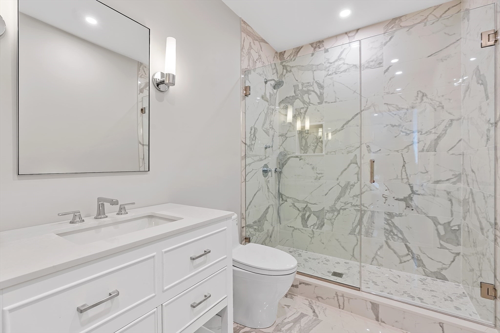 5 Colonial Road, Unit 5 Needham, MA 02492 - Photo 33 of 35 a bathroom with a sink a toilet and shower
