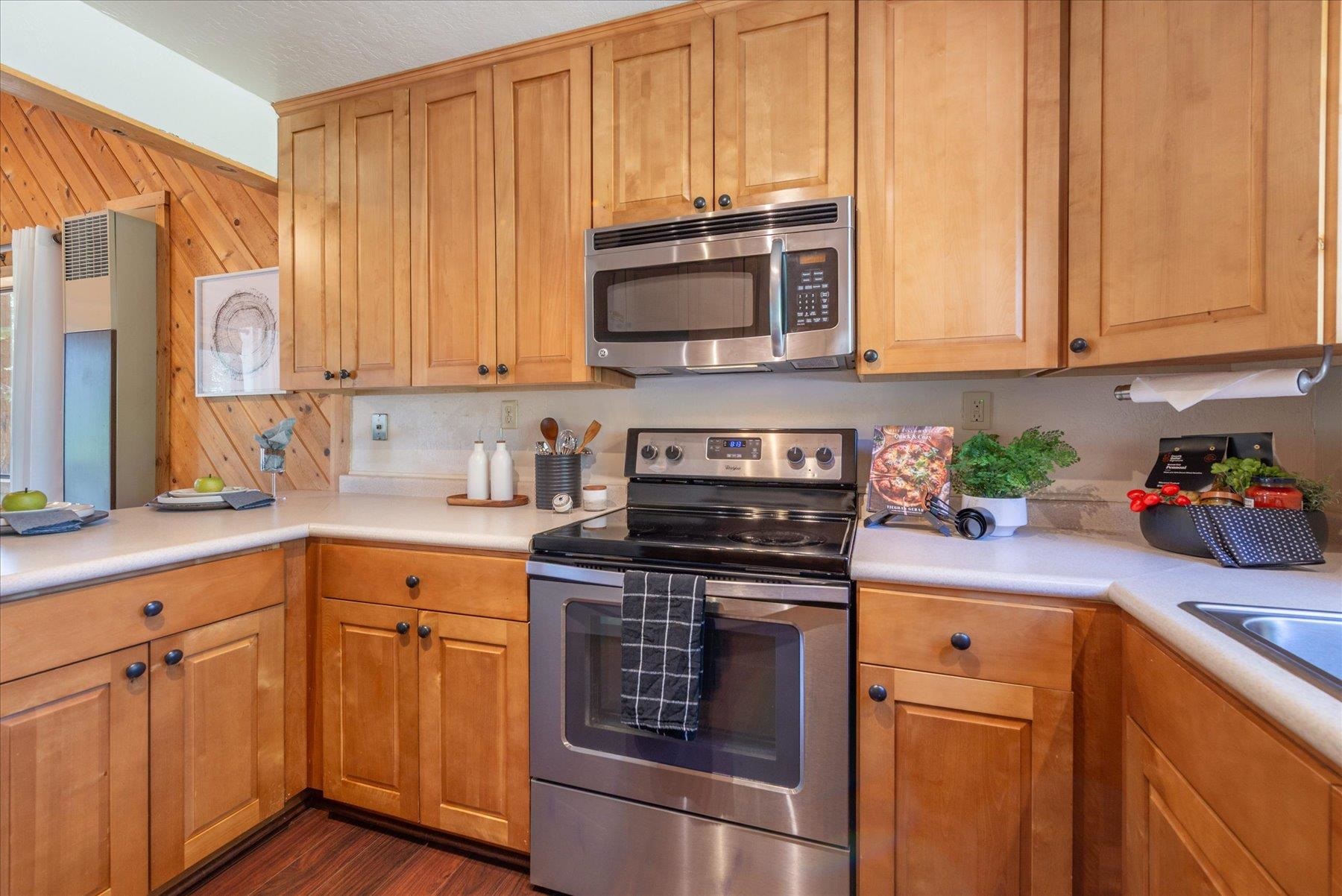 325 North Ridge Road Carnelian Bay, CA 96140 - Photo 15 of 22 a kitchen with stainless steel appliances granite countertop a sink a stove and a microwave