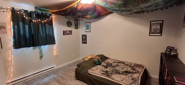 a bed sitting in a kitchen next to a cabinet