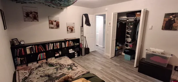 a bed room with a bed and a book shelf