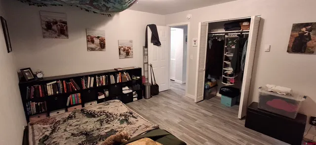 a bed room with a bed and a book shelf