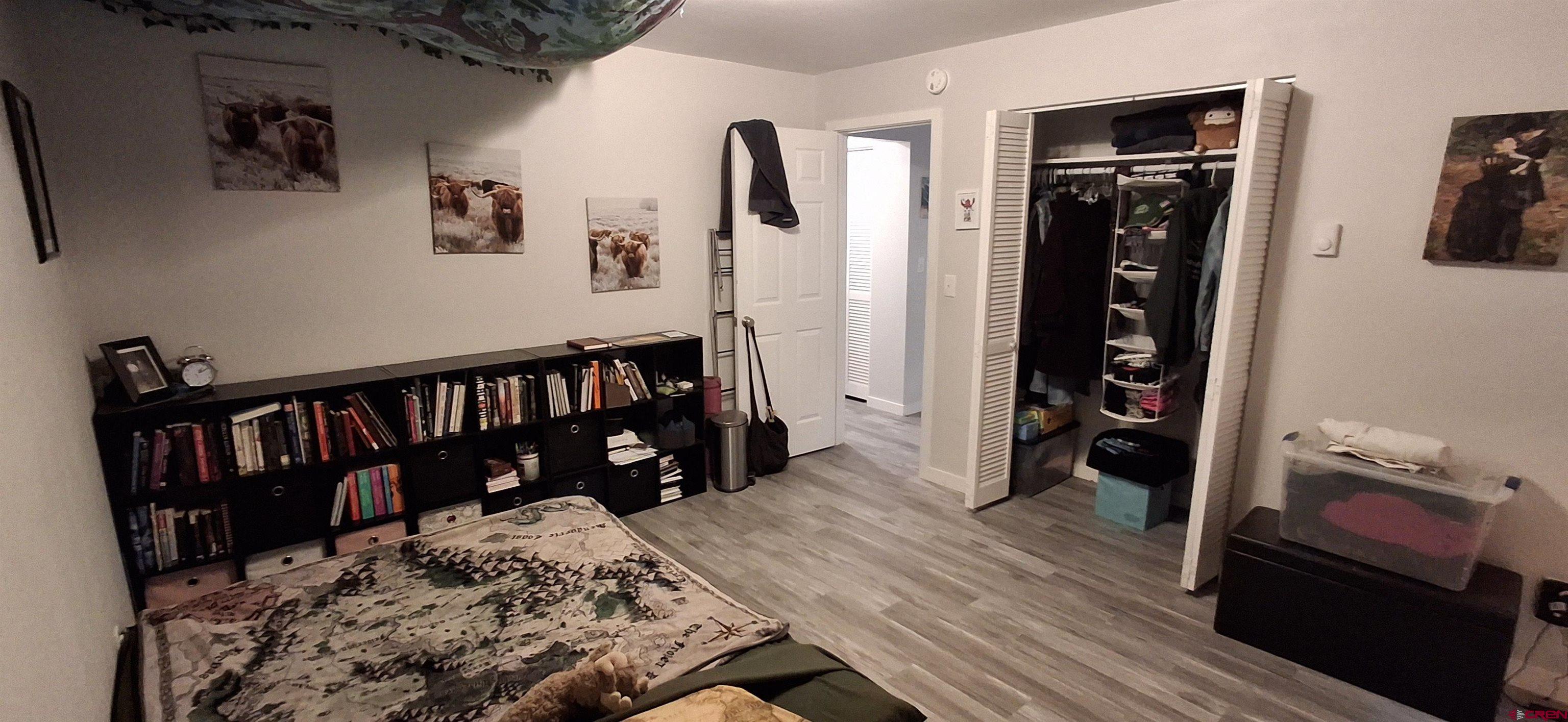 306 North 9th Street, Unit 1B Gunnison, CO 81230 - Photo 6 of 8 a bed room with a bed and a book shelf