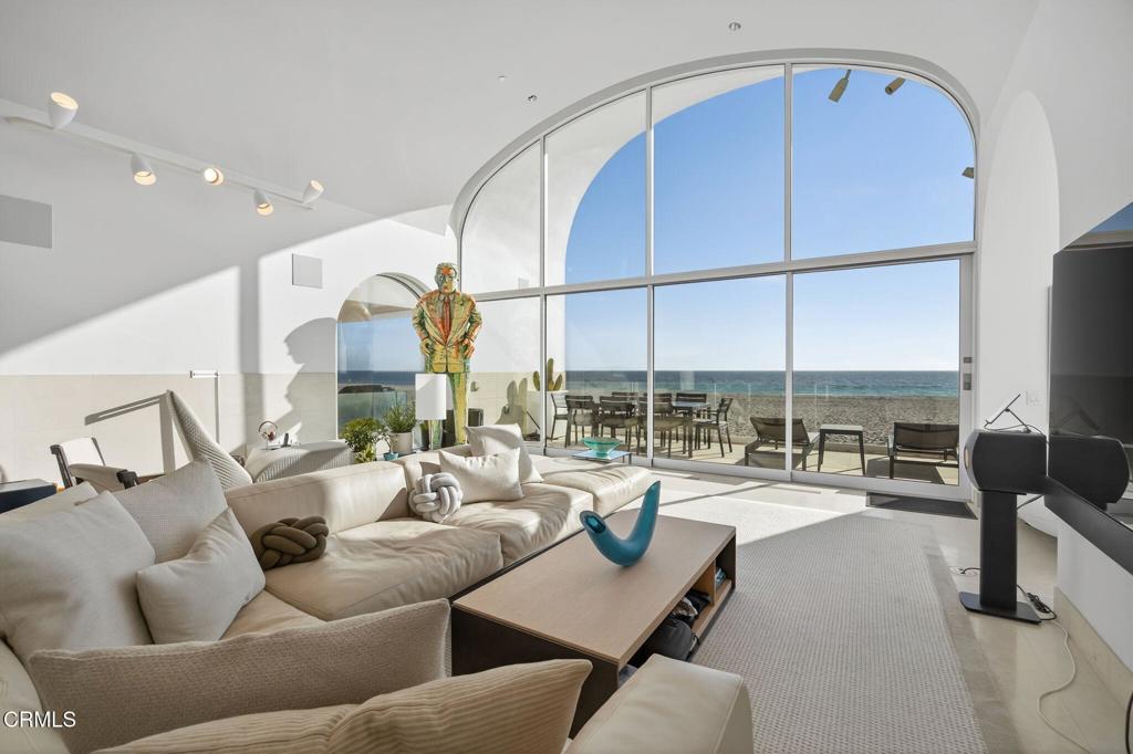 1211 Capri Way Oxnard, CA 93035 - Photo 21 of 63 a dining room with furniture a floor to ceiling window and a flat screen tv