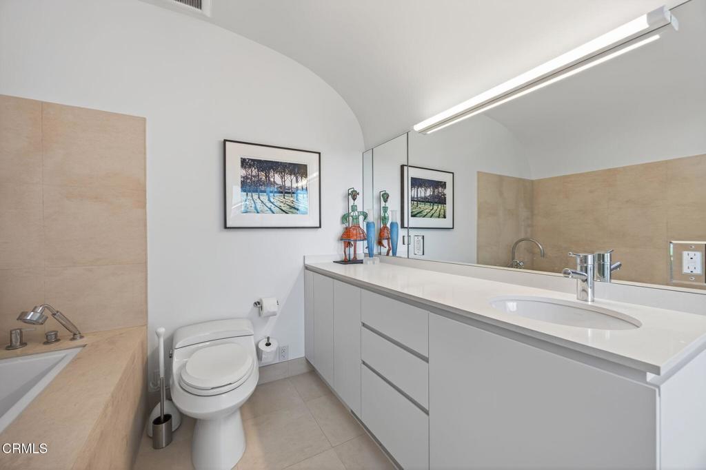 1211 Capri Way Oxnard, CA 93035 - Photo 40 of 63 a bathroom with a toilet sink and mirror