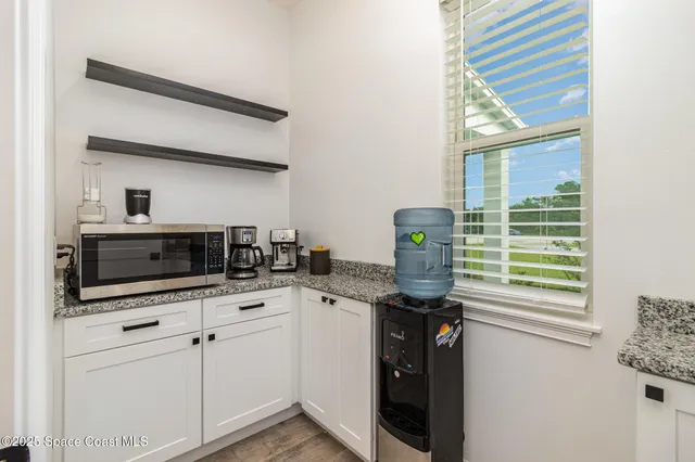 a kitchen with a sink cabinets and appliances